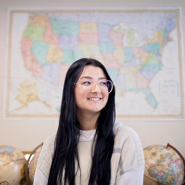 Geography Student in front of Map
