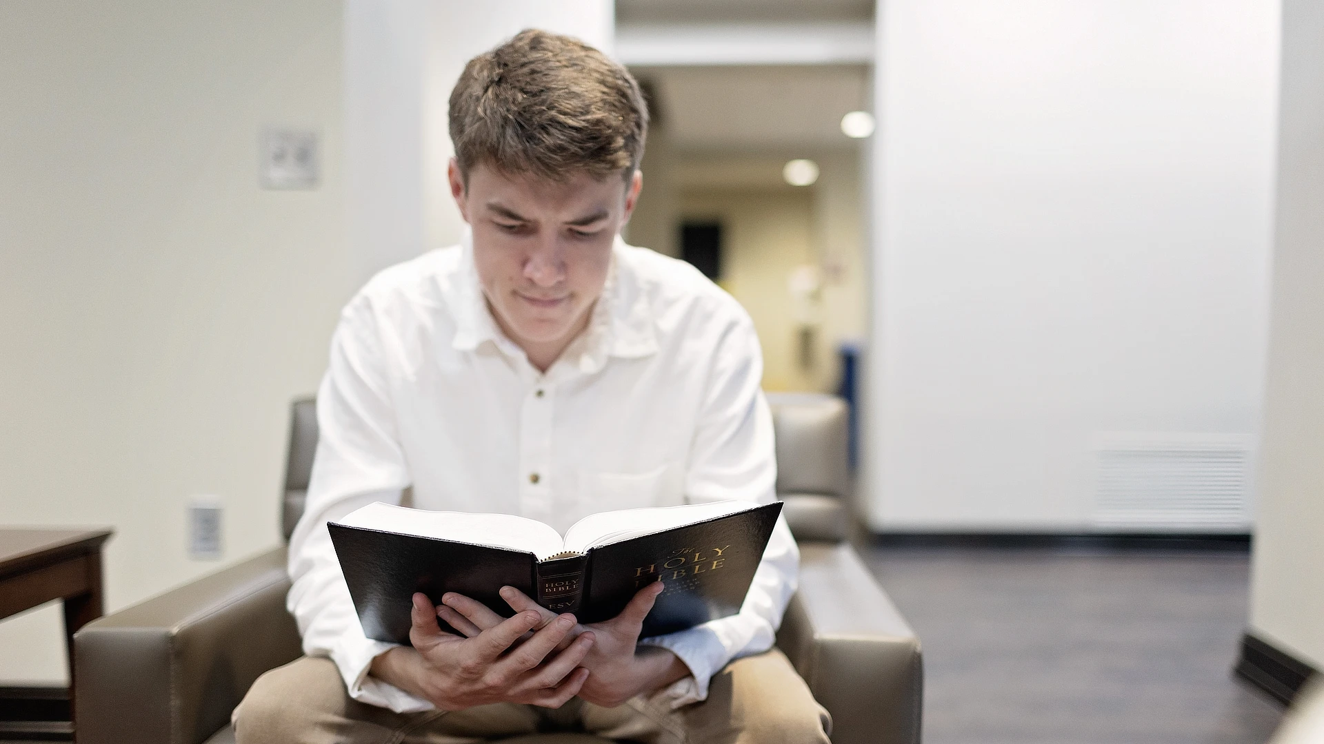 male student reading the bible