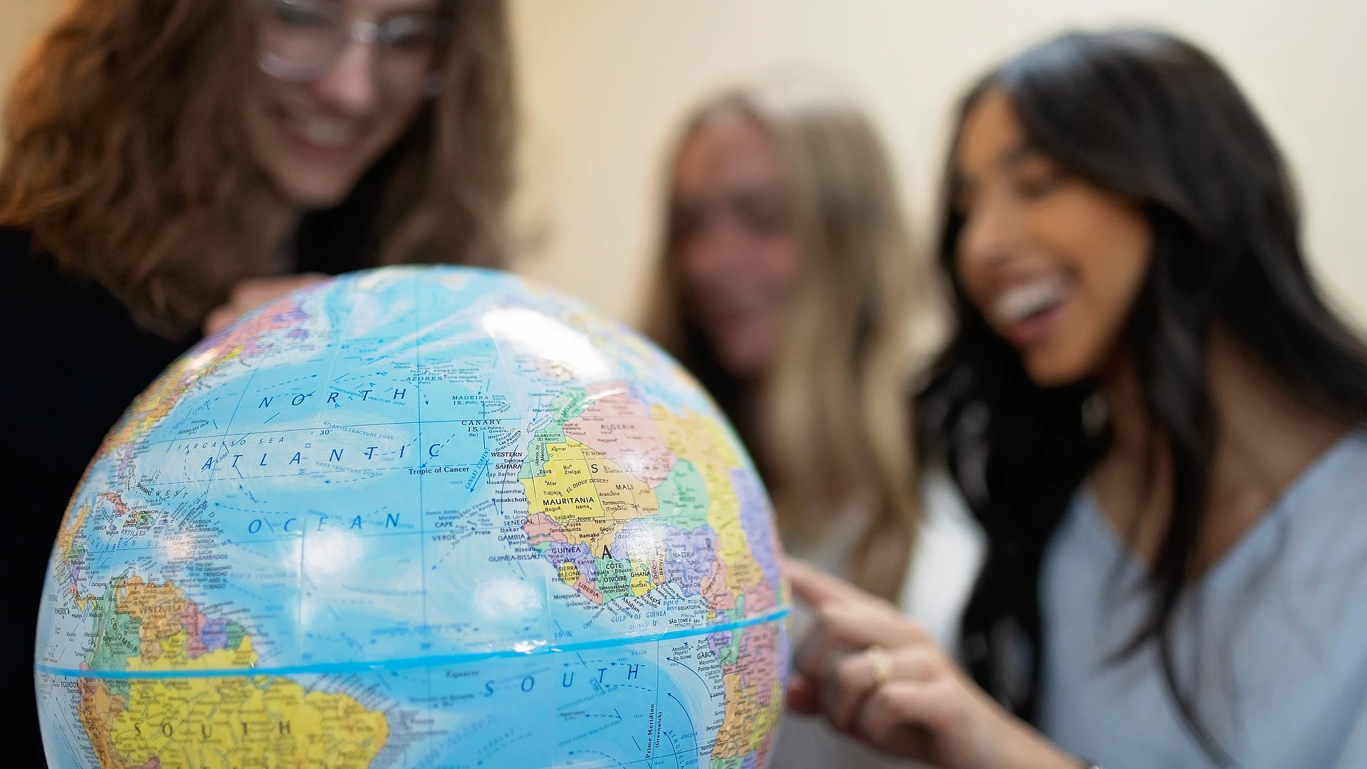 students looking at a globe