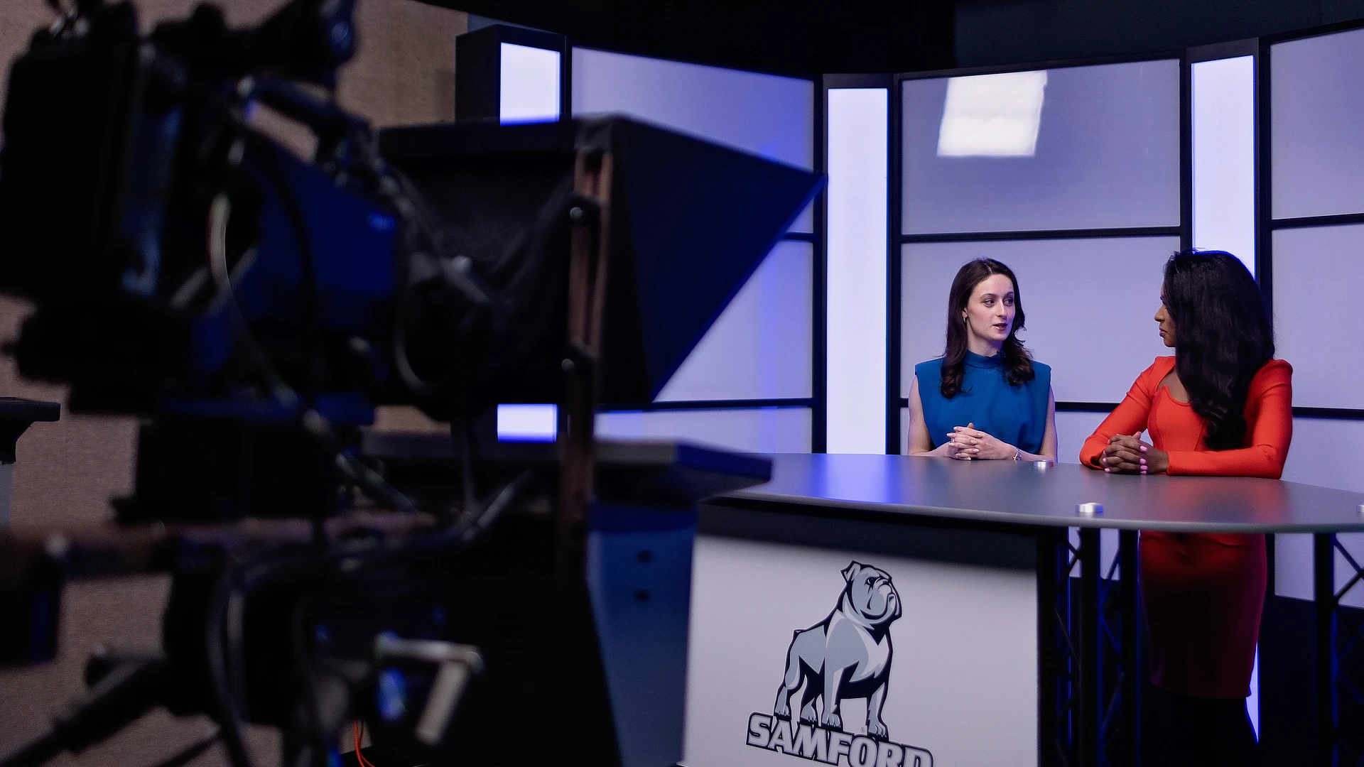 two female students sitting at a desk