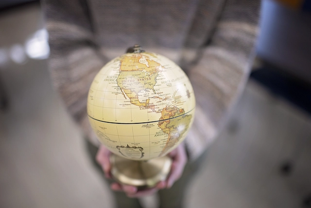 hands holding a globe