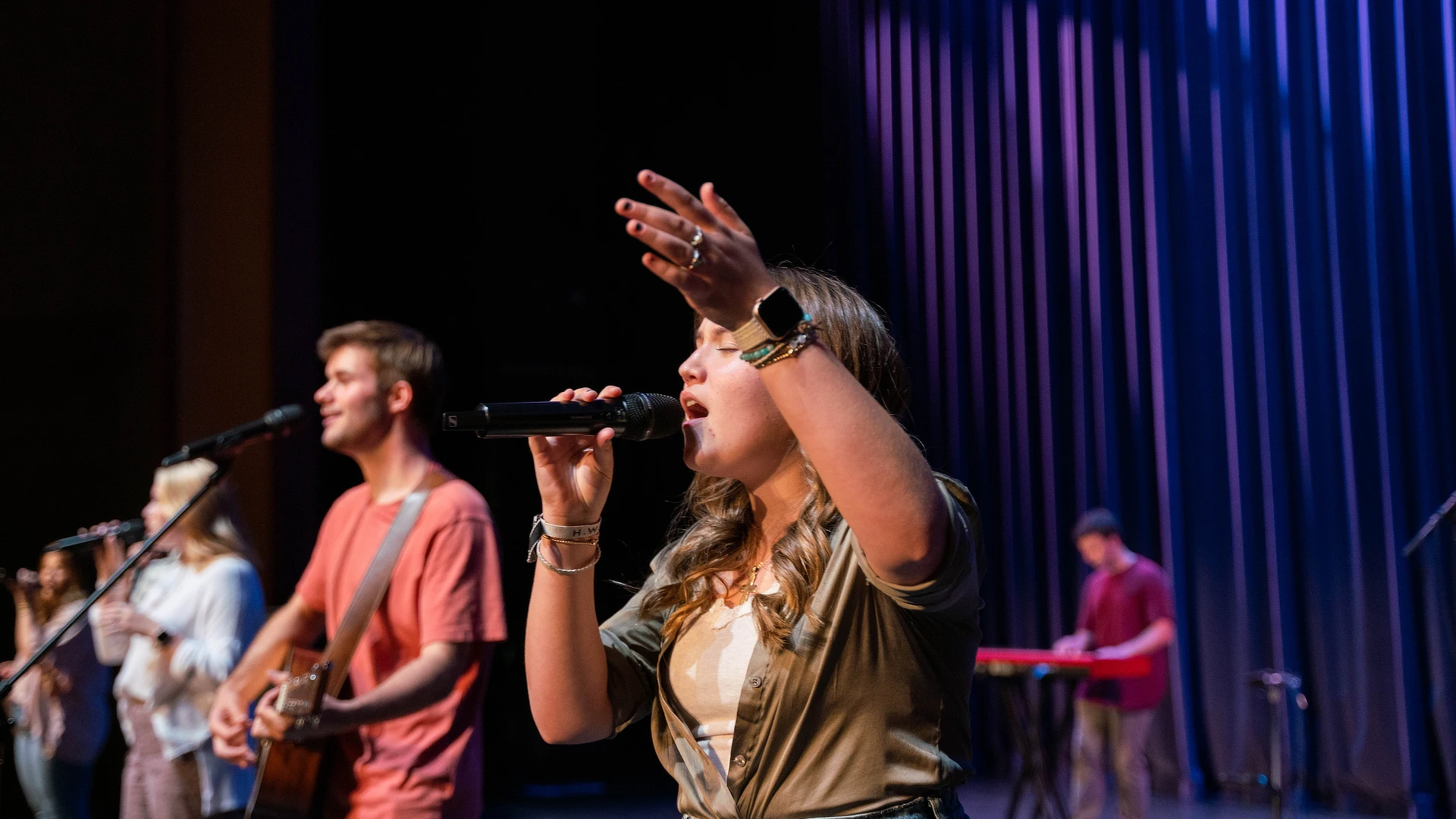 Female Student Leading Worship Team