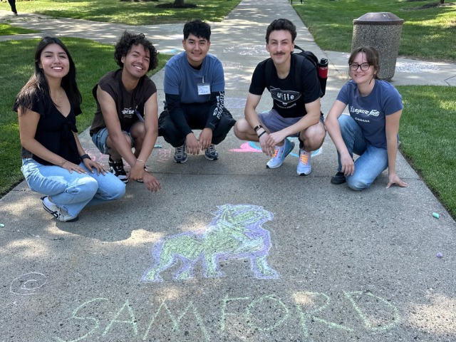 Students with Samford sidewalk chalk drawing