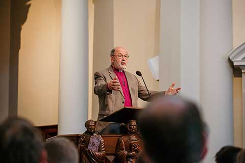 minister leading chapel worship