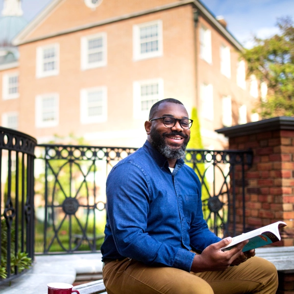 smiling man with book