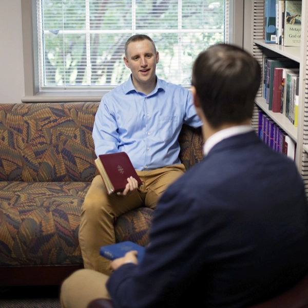 man with bible in conversation