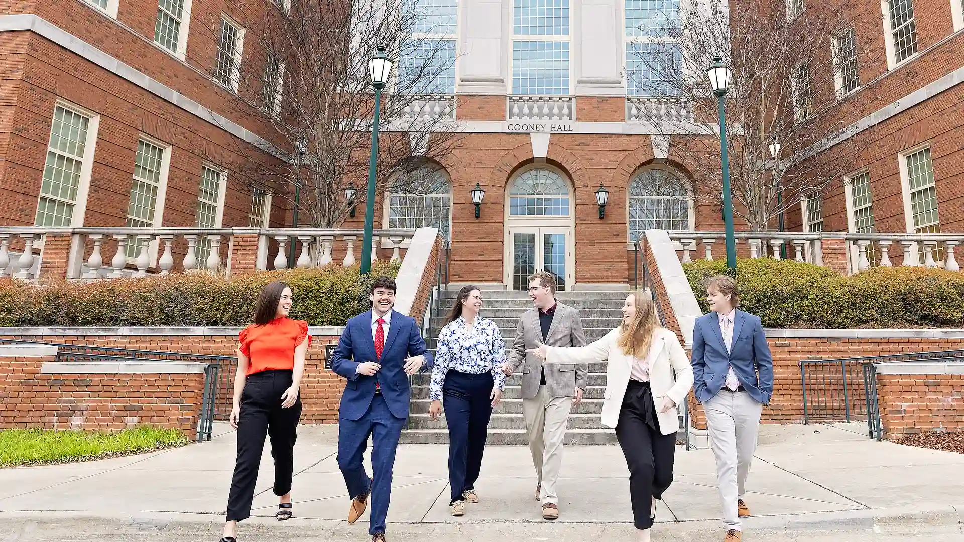 business students walking down the stairs of cooney hall DR03222024618