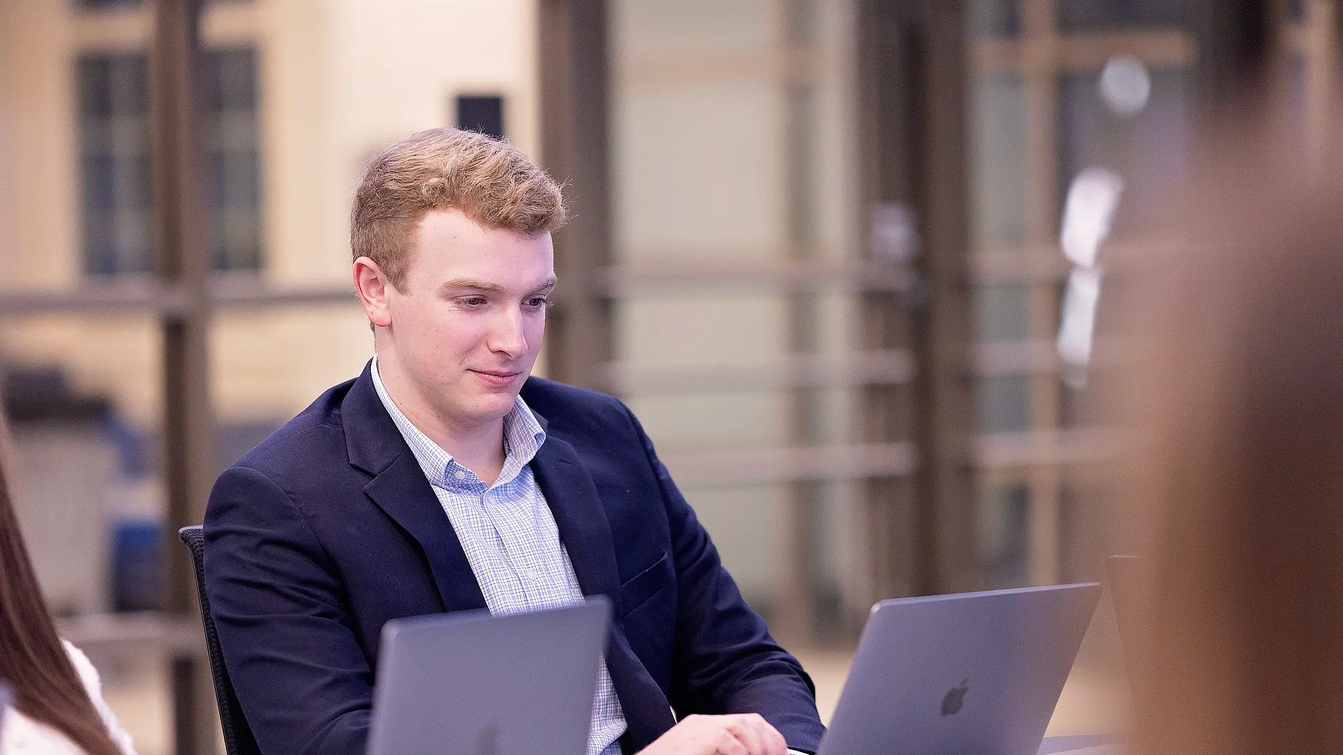 male business student working on laptop