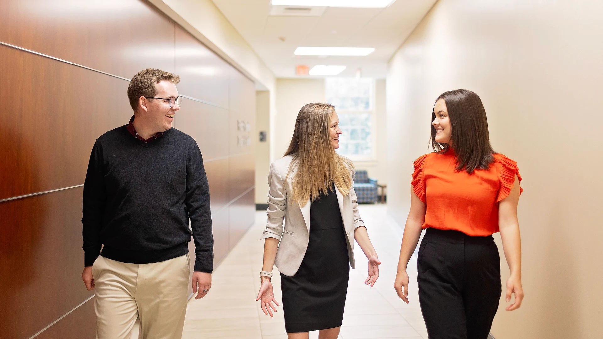 three business students walking in the hall