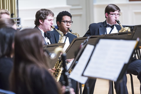 Three male wind ensemble players