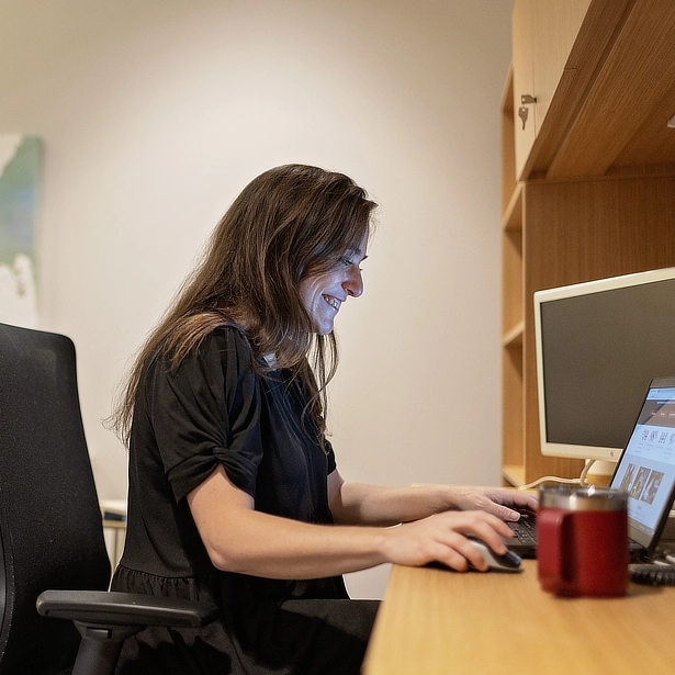 counselor smiling at computer