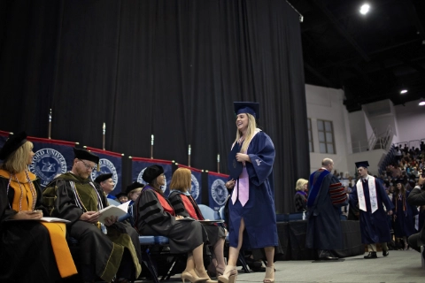 woman with diploma striding DR04292022686