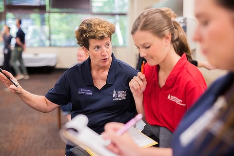 Professor conversing with students