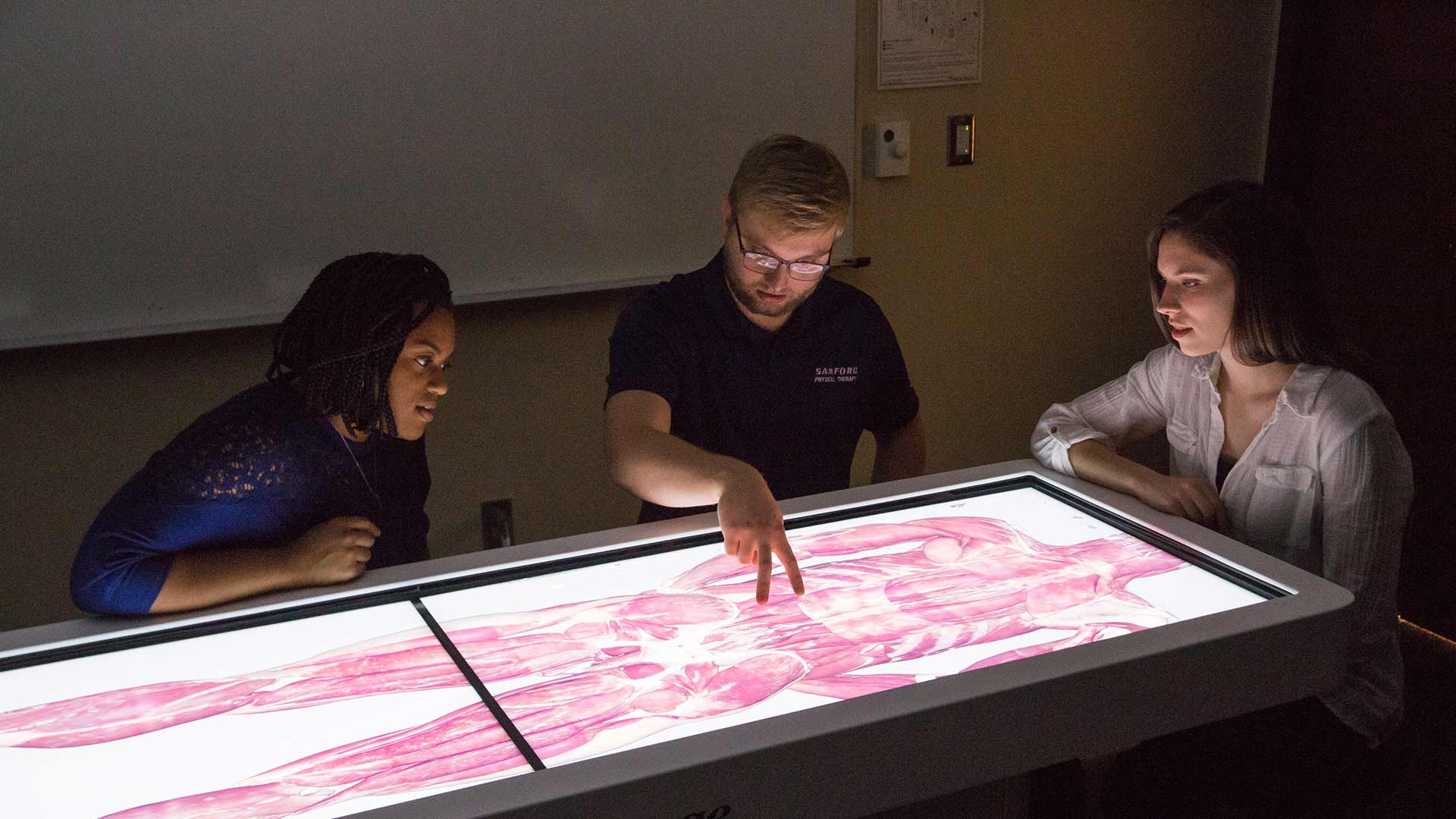 three students at anatamoge table