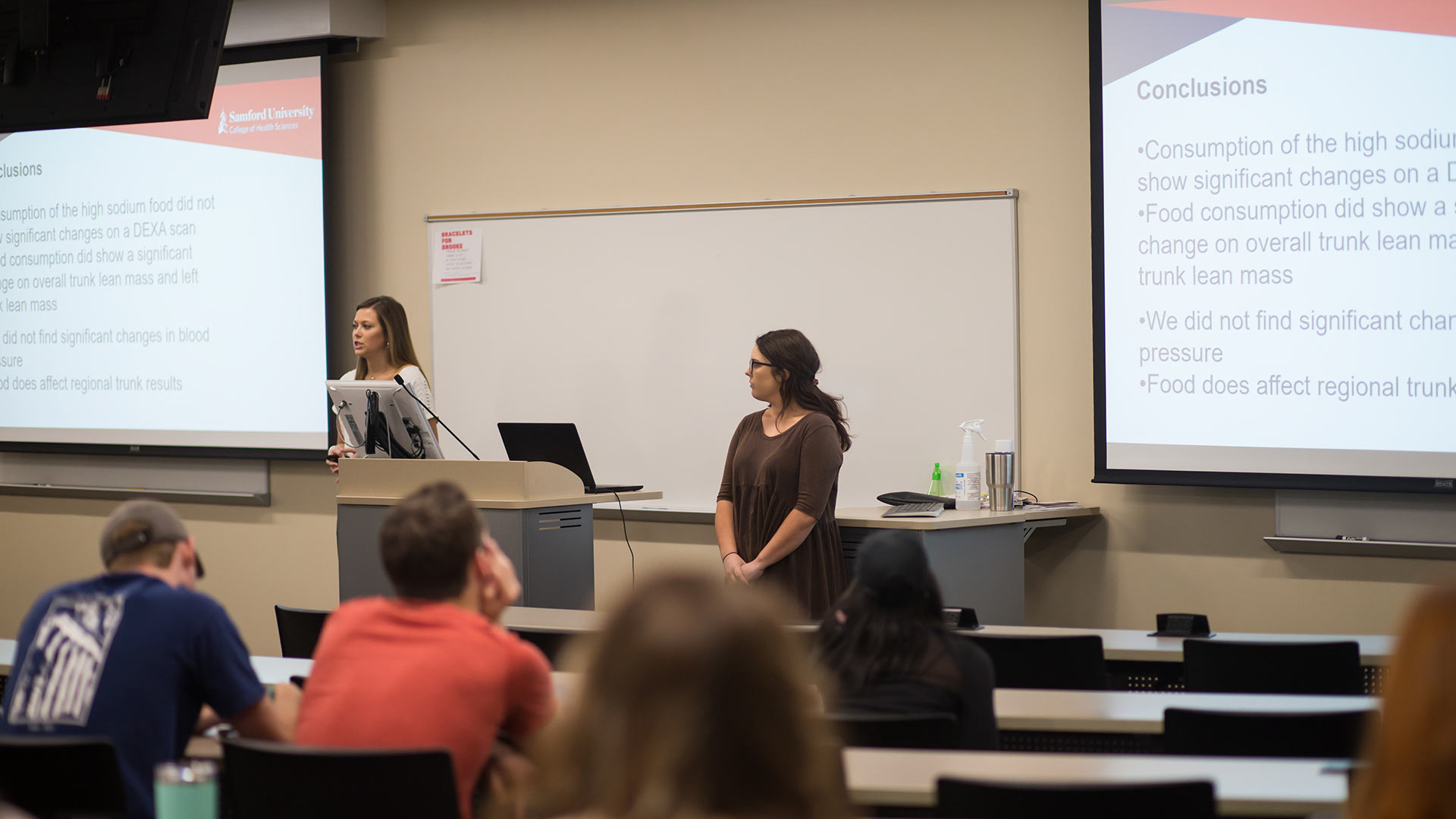 two students presenting research results