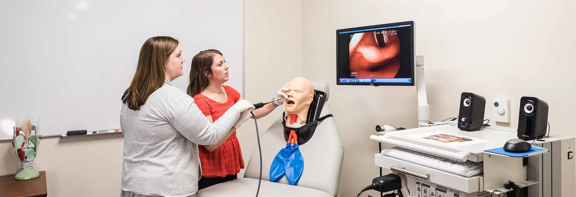 two female students performing simulation