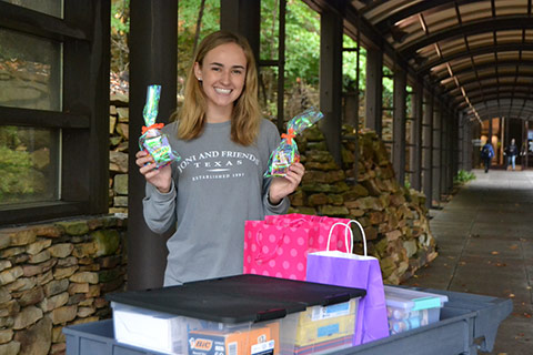 student holding gifts