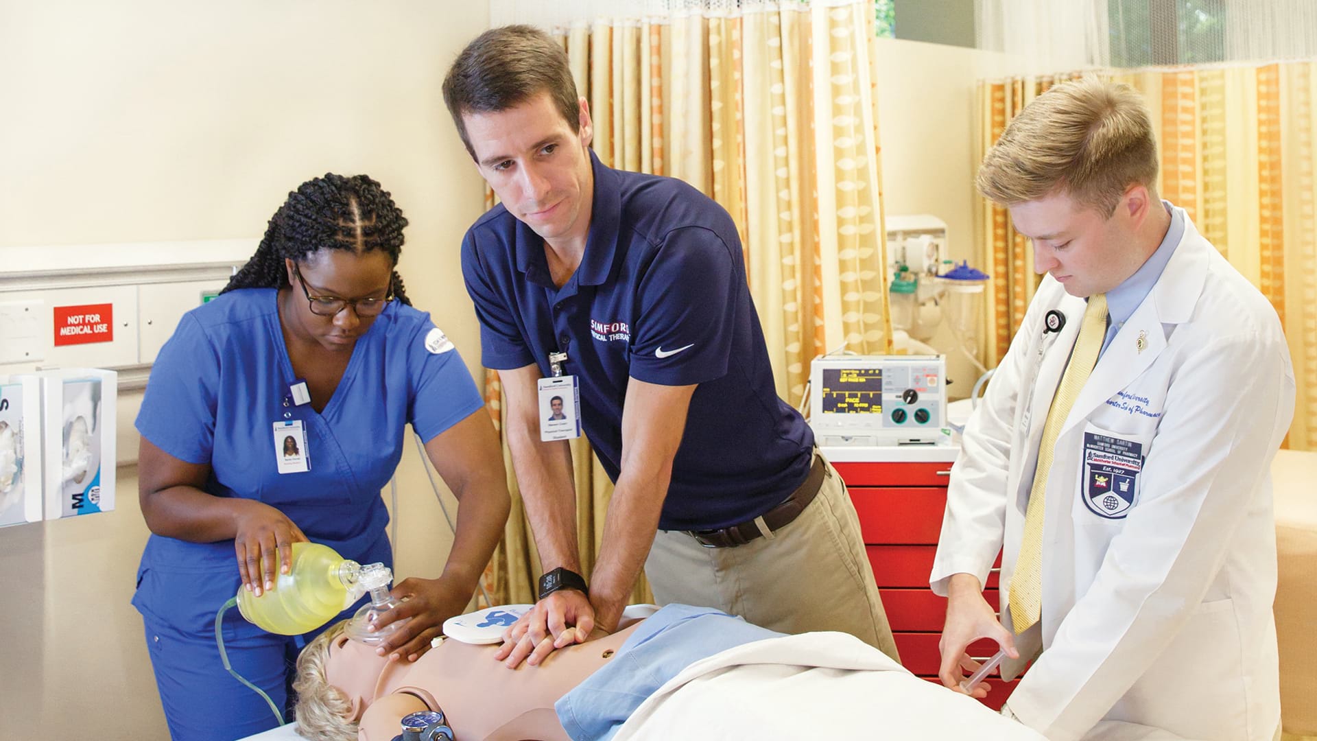 Students working a code with a patient