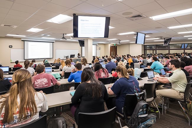 Pharmacy students in a large classroom in CHS