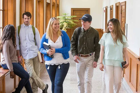 female and male students walking in the hall 480x320