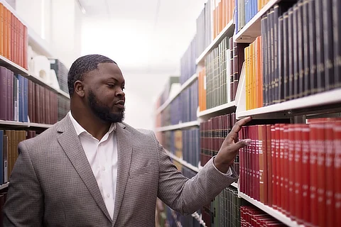 male student browsing shelves 480x320