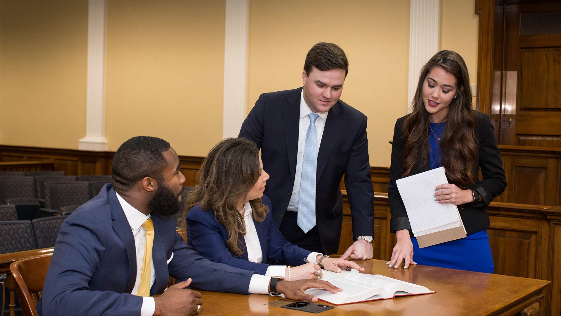 female and male students discussing case