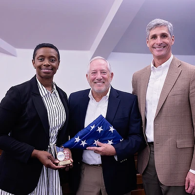lawyers holding a folded flag
