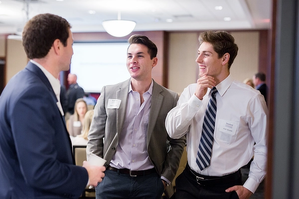 Three Students Talking At Conference