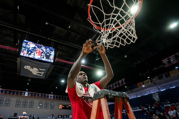 Jermaine cutting down net