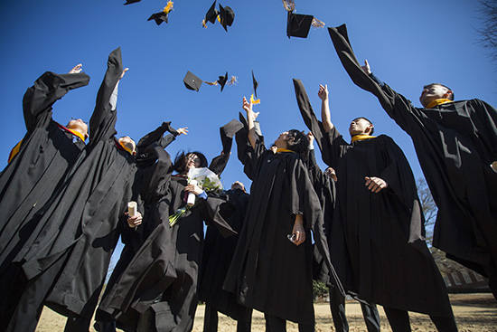 graduates throwing their caps in the air