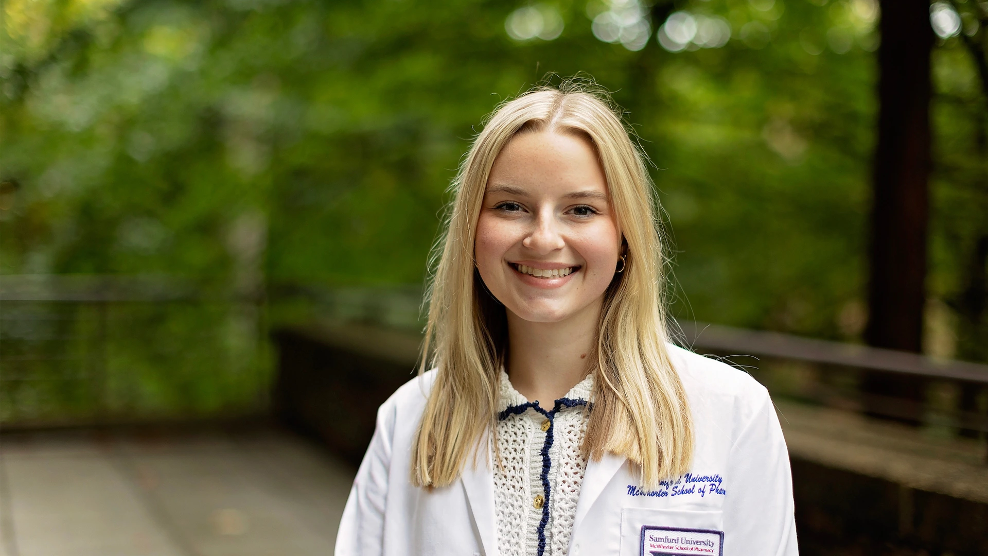 female student white coat outside