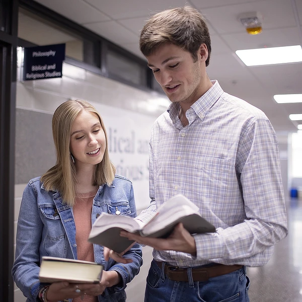 two students reading the bible