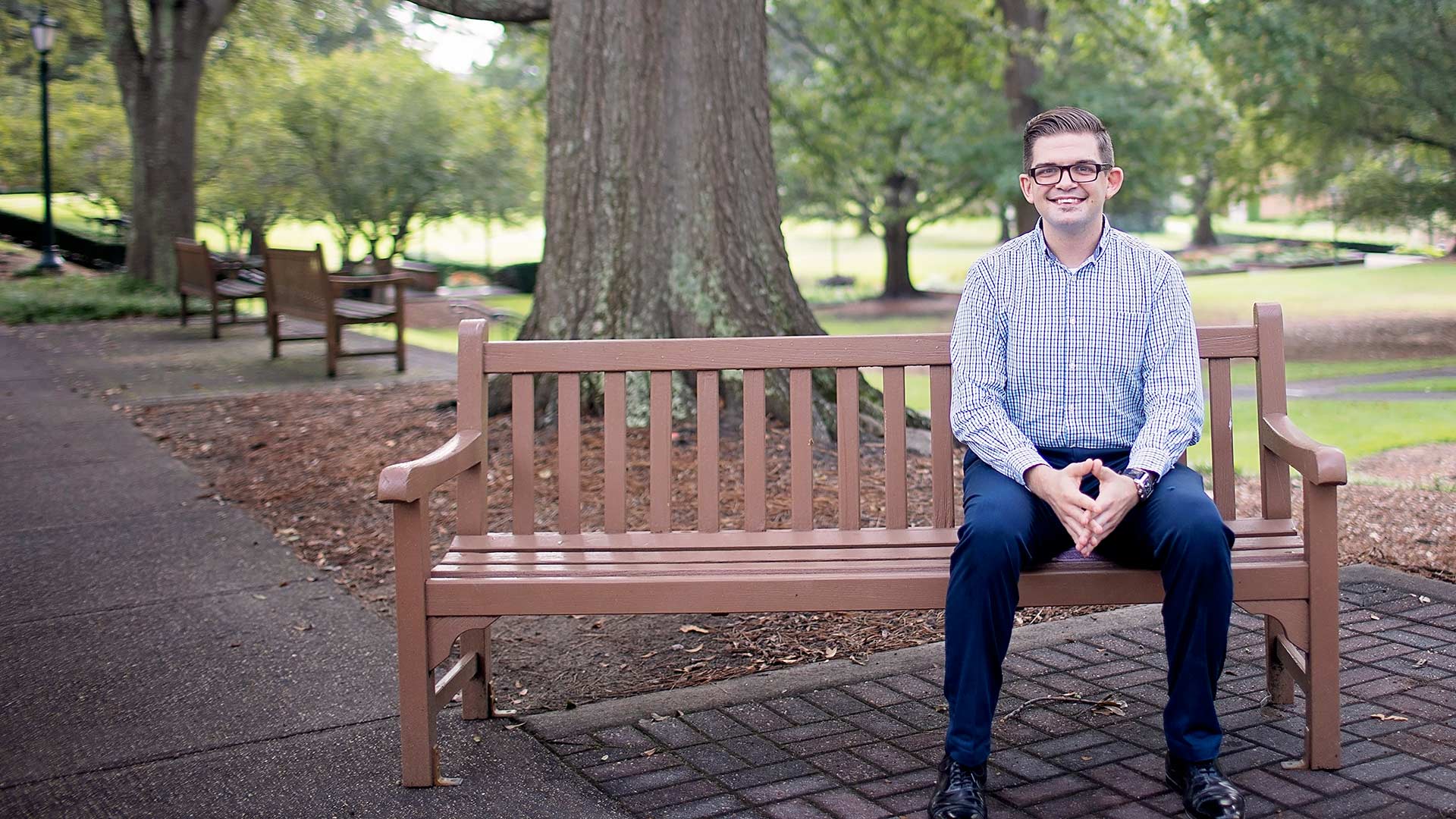 ph student sitting on bench