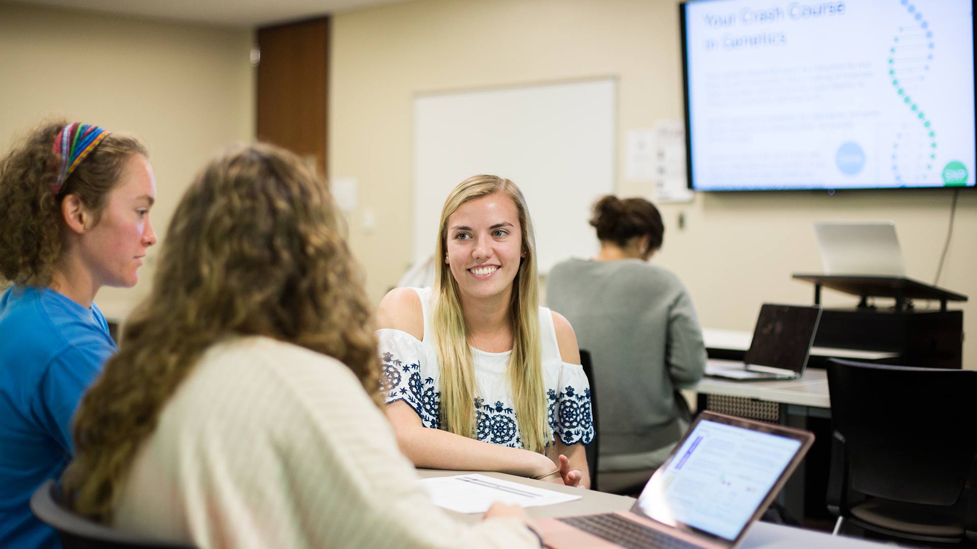 three female public health students discussing assignment