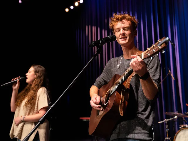 two students leading worship